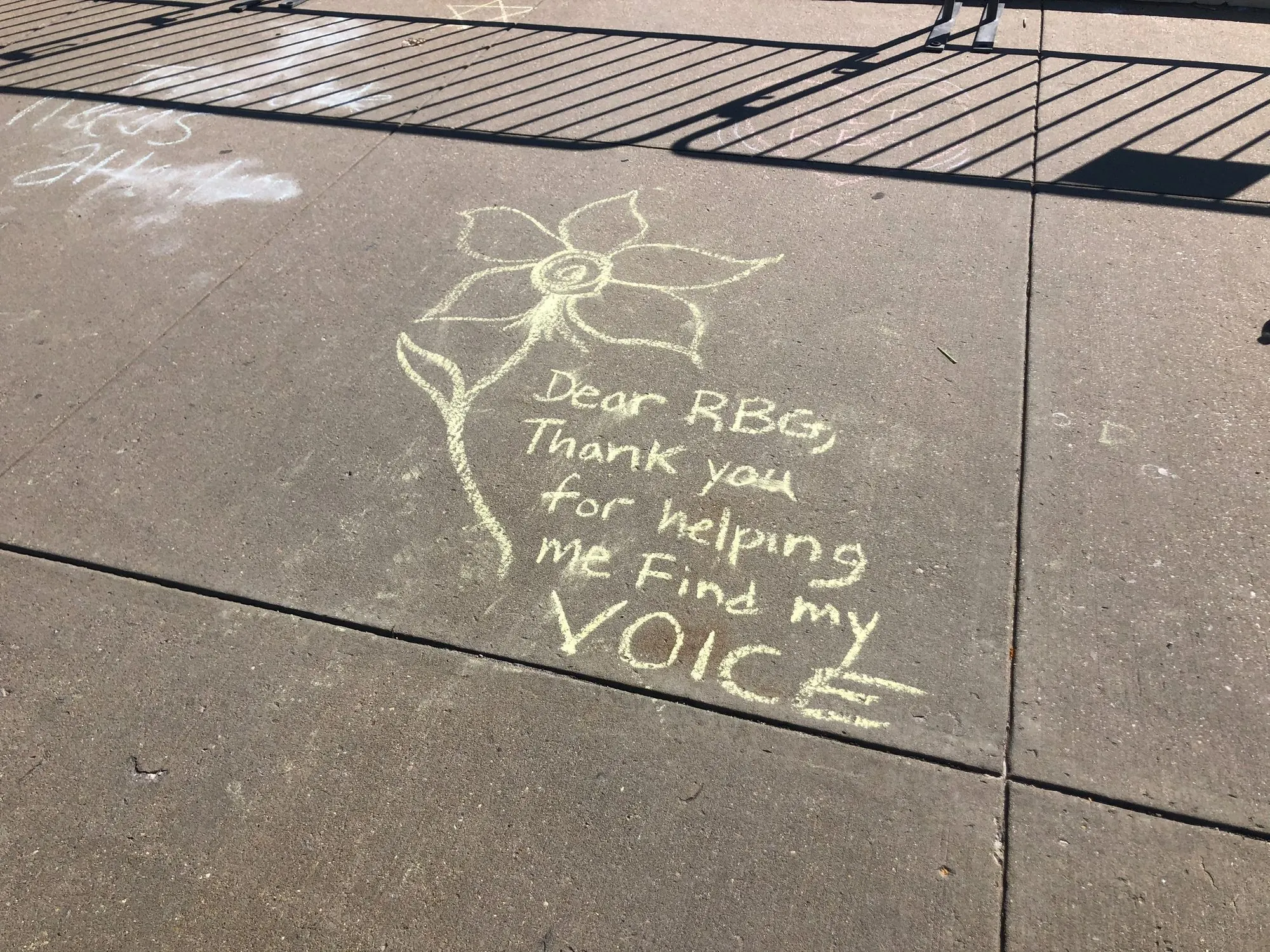A chalk message thanking Ruth Bader Ginsburg for helping the writer find their voice