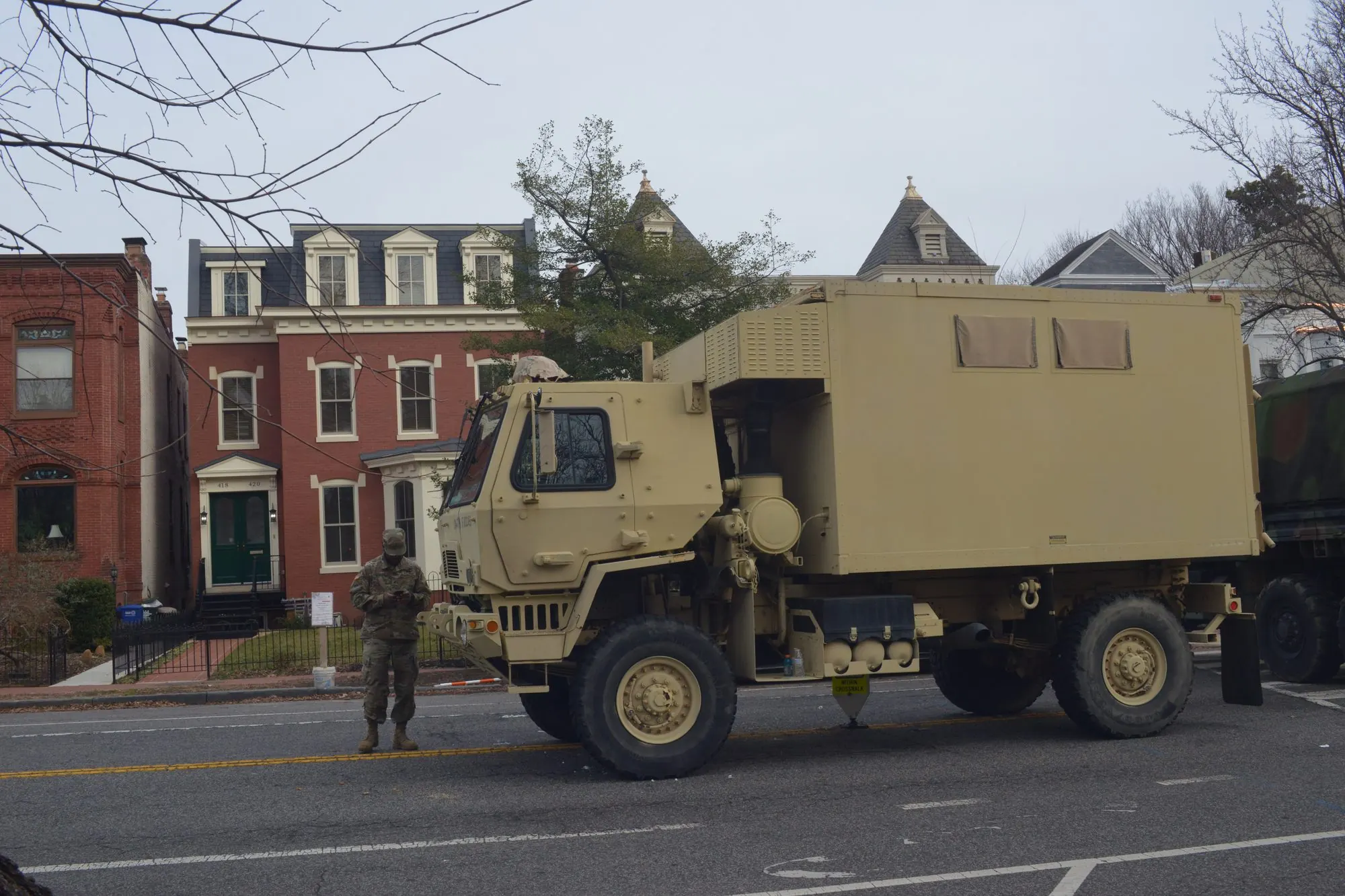 A military vehicle parked on a residential Washington street