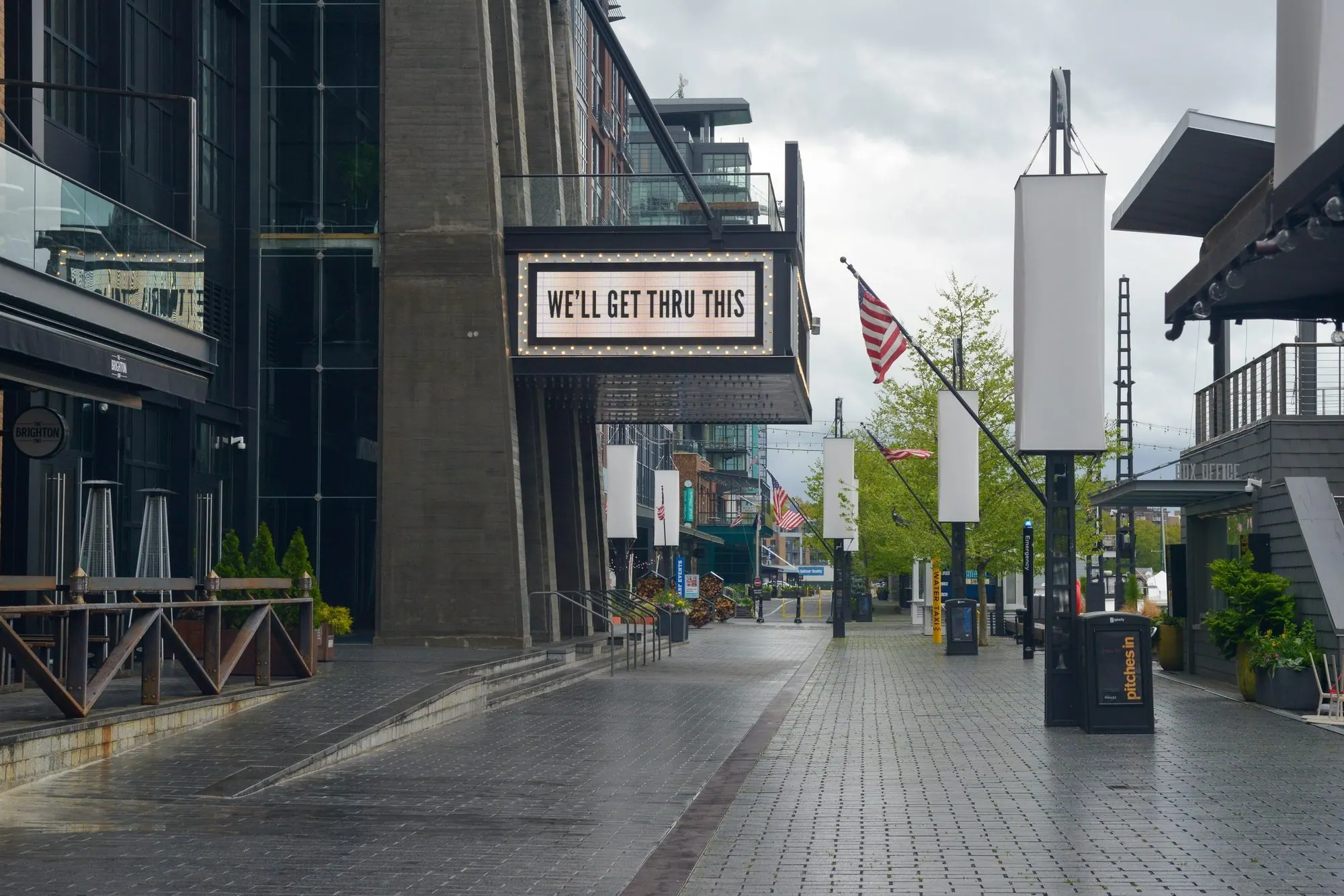 An empty street and a marquee reading We'll get thru this