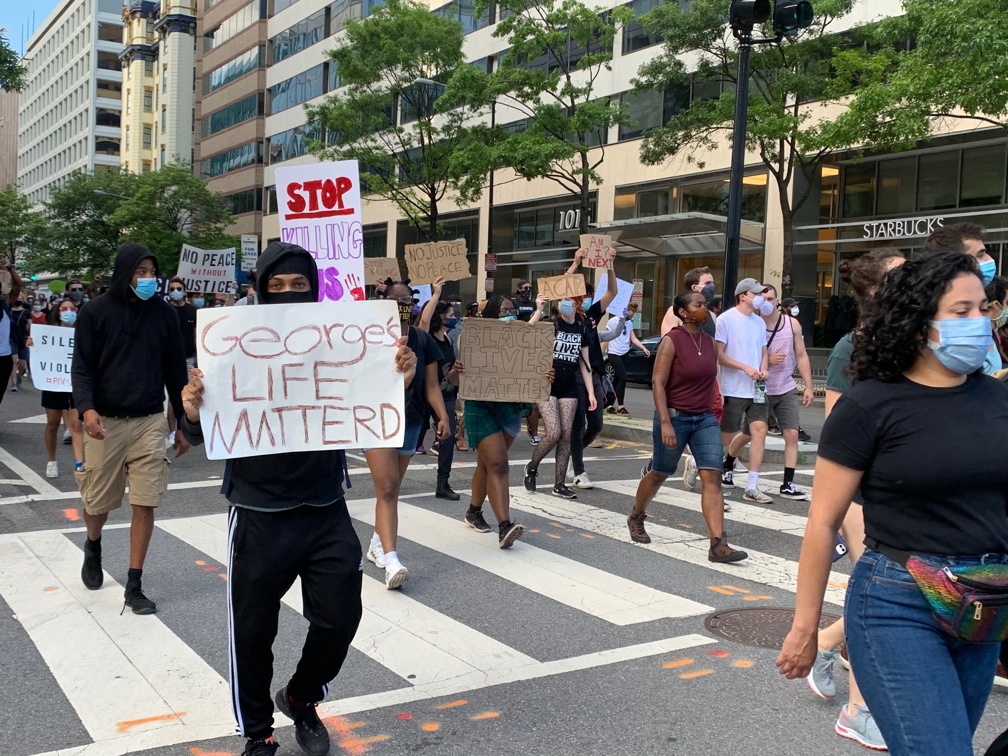 Masked Black Lives Matter protesters marching through downtown Washington, DC