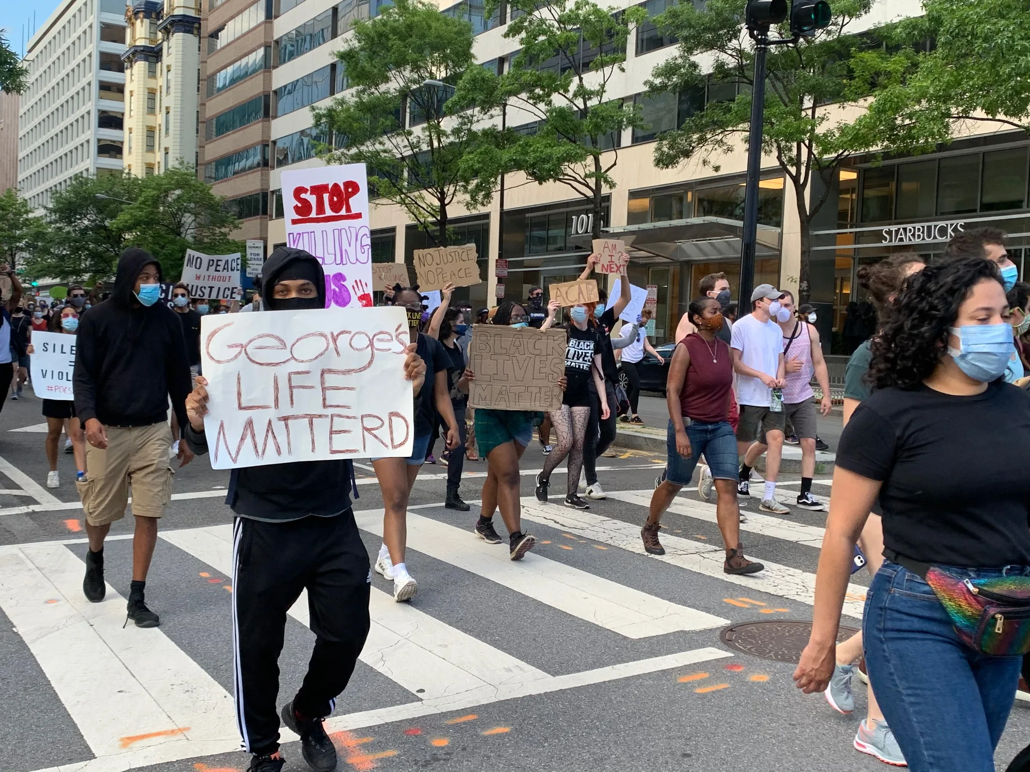 Masked Black Lives Matter protesters marching through downtown Washington, DC
